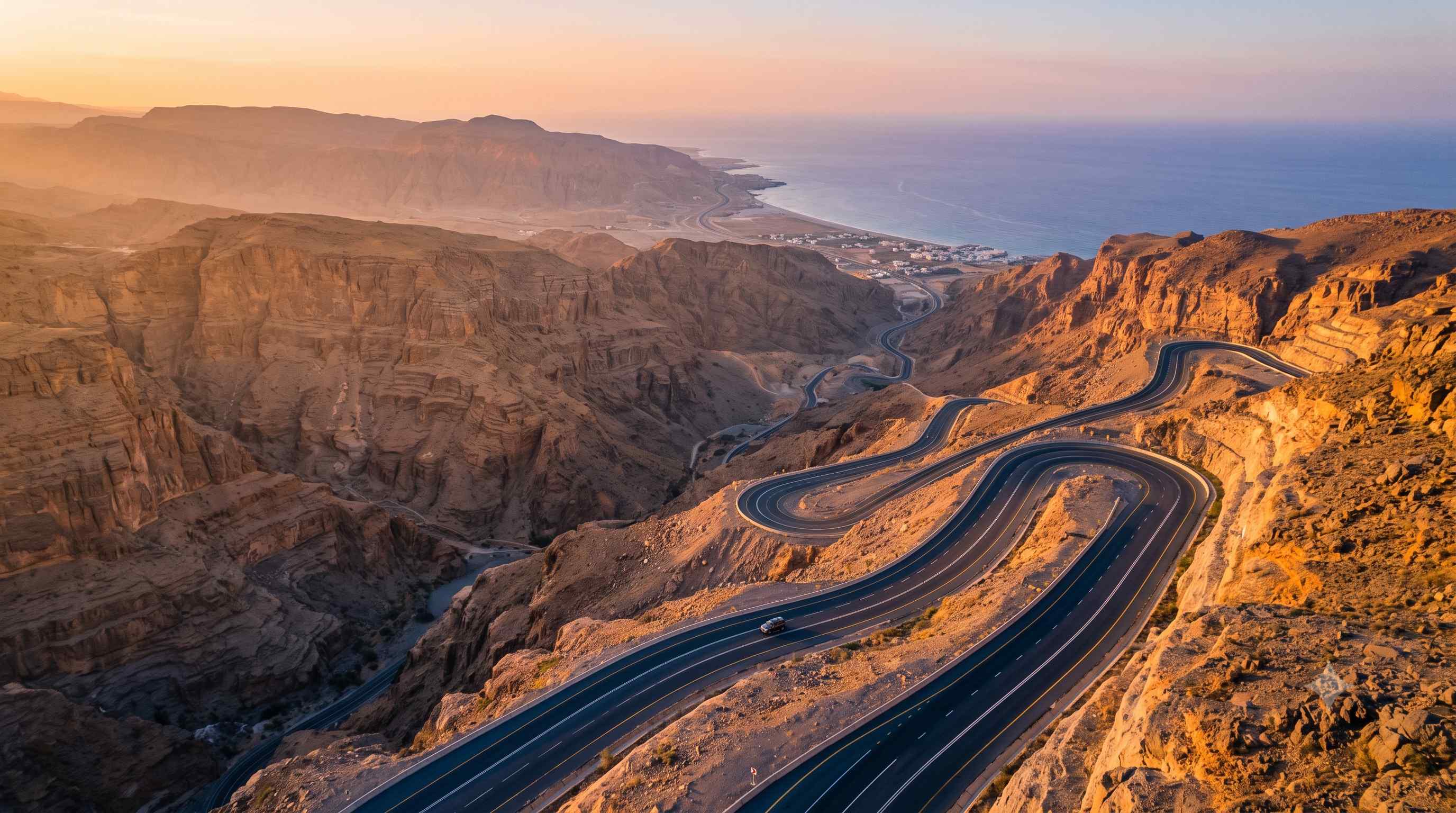 Winding mountain highway through the Hajar mountains at sunset